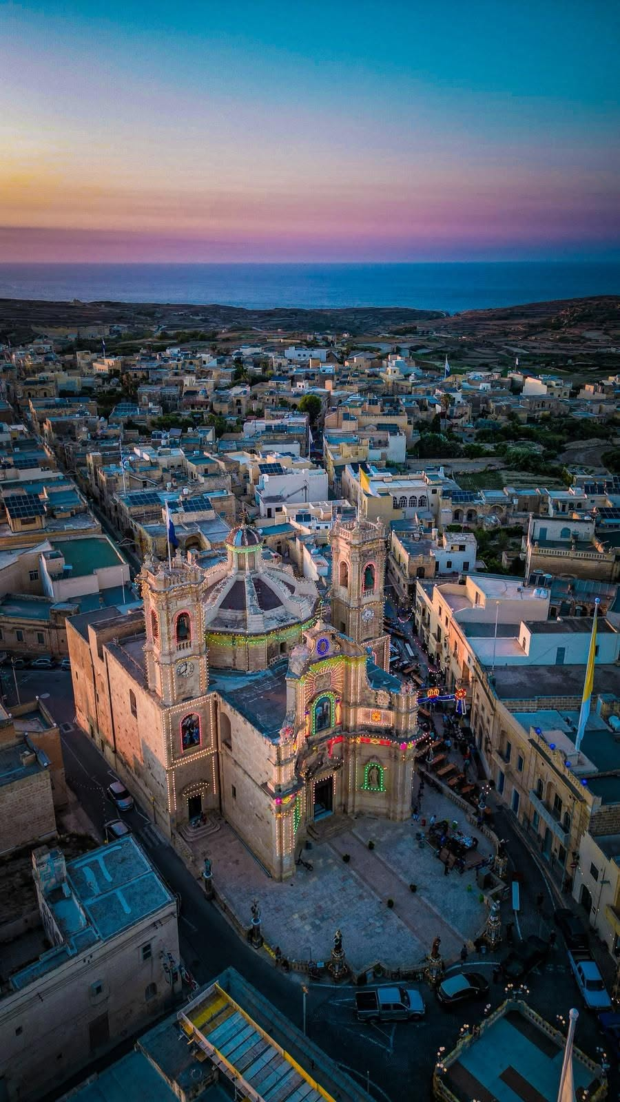 Aerial dusk view of Gharb village and church in Gozo