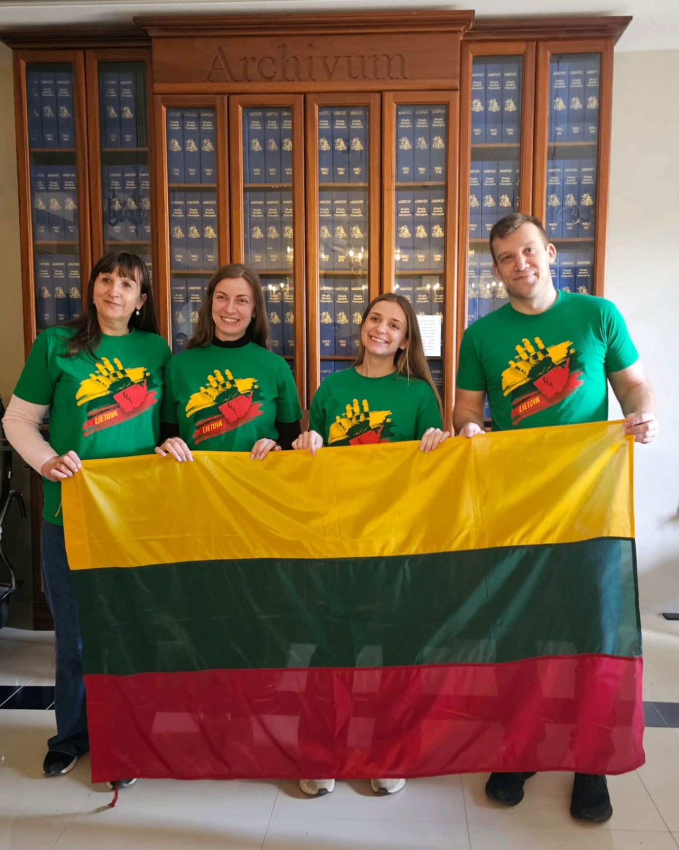 Project participants holding a Lithuanian flag during an international mobility activity