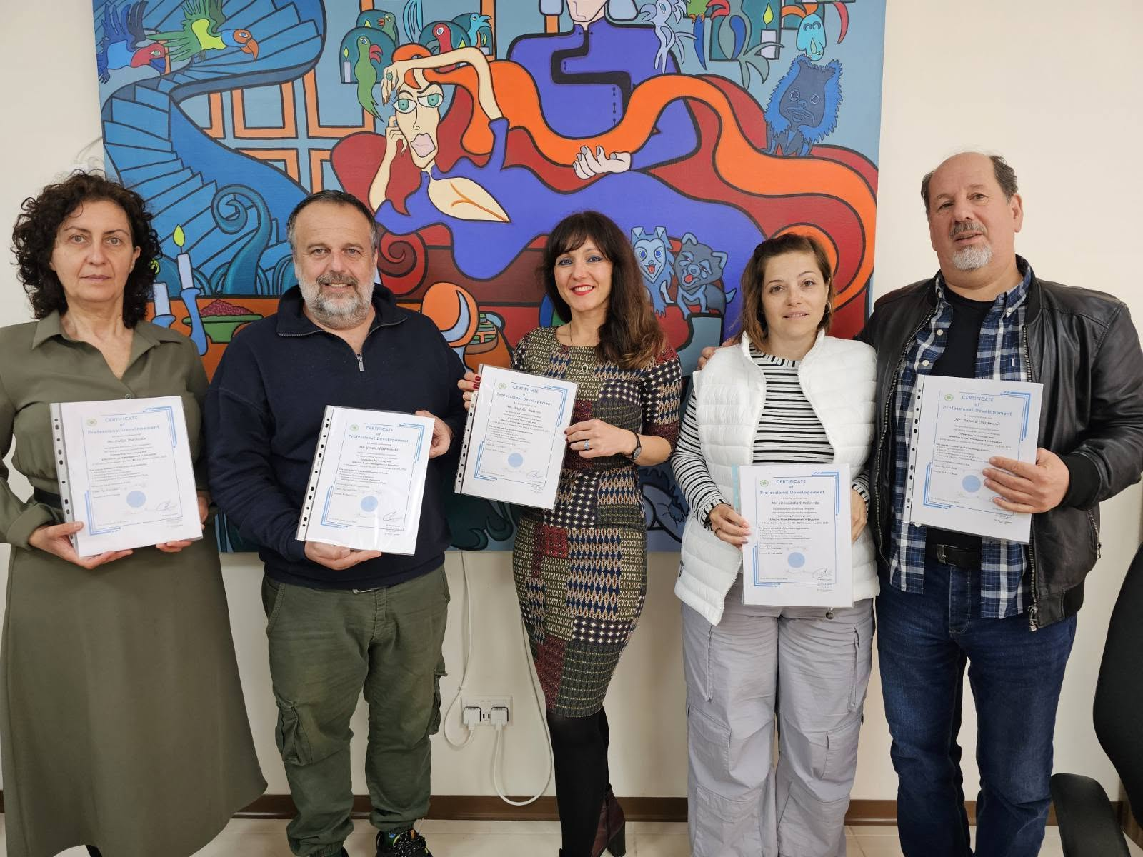 International group of educators holding certificates after a completed course