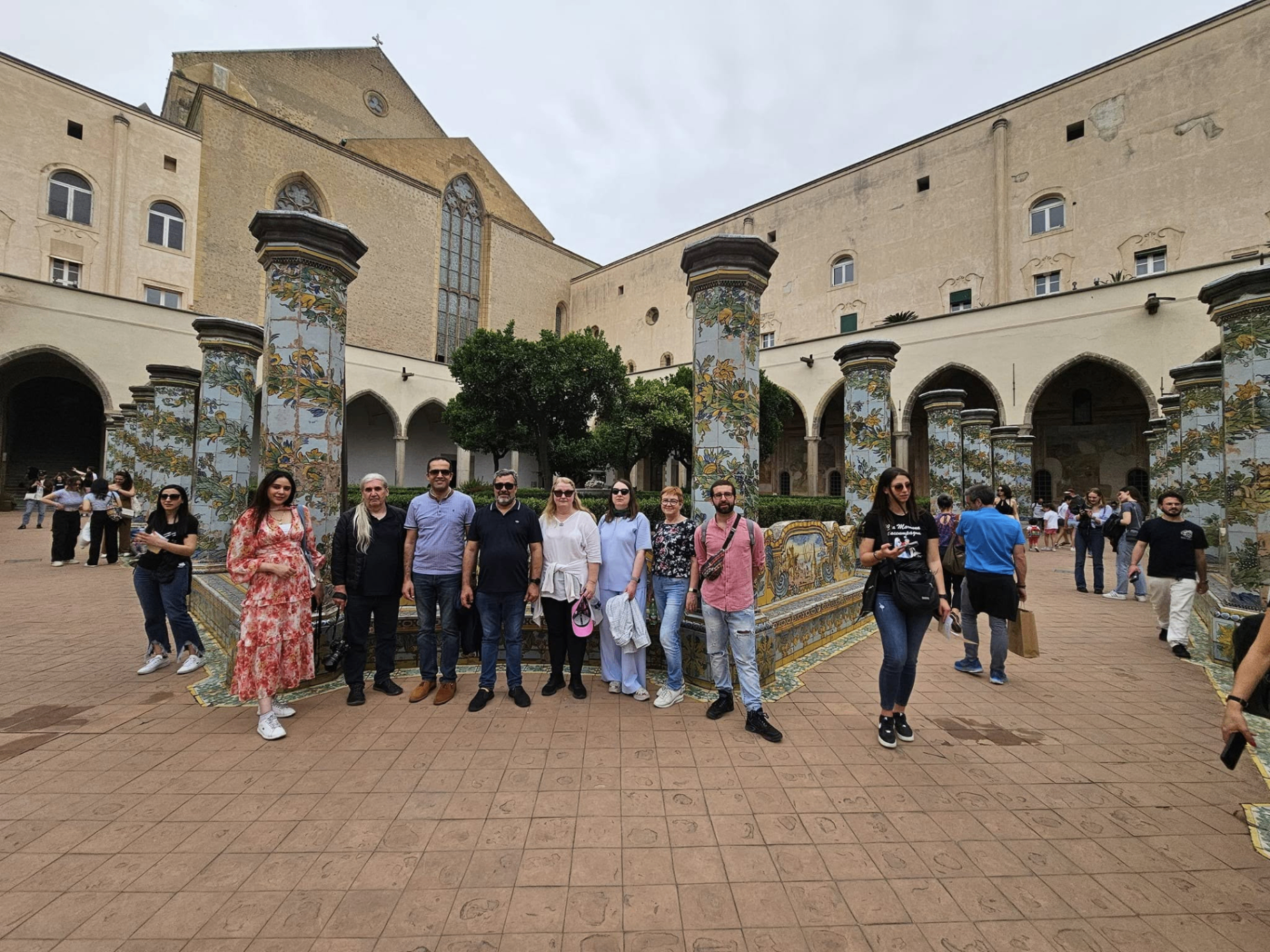International participant group during a study visit in a historic courtyard